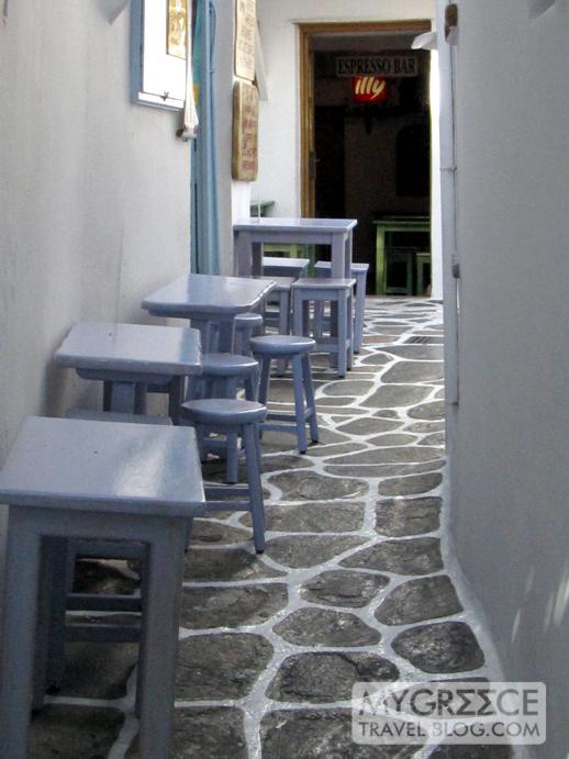 cafe tables on a narrow Mykonos street 