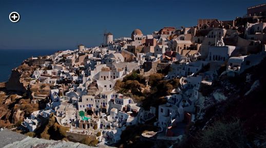 Santorini Freedom film view of early morning sunshine on the village of Oia