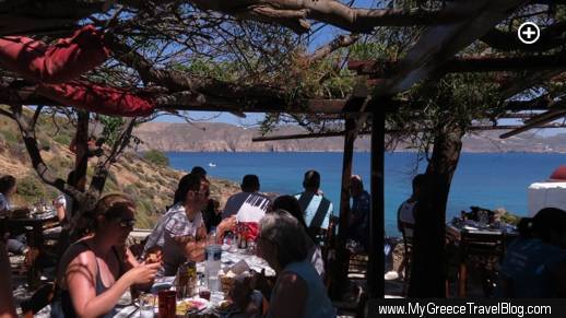 The tree- and vine-sheltered dining terrace at Kiki's taverna at Agios Sostis beach on Mykonos