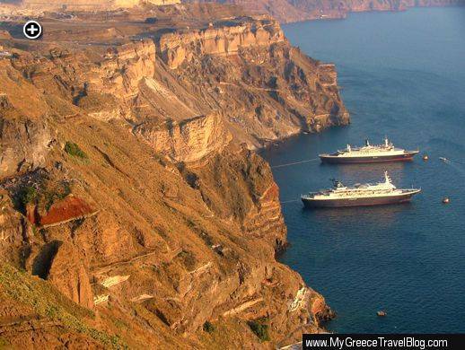 Two cruise ships at anchor below the impressive caldera cliffs on Santorini