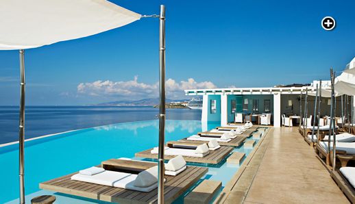 Cavo Tagoo Mykonos website photo of the hotel's infinity pool and luxurious sundeck