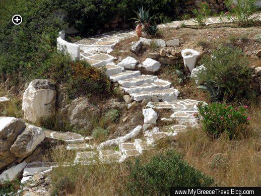 a path of cement steps winds down the hillside above Tzamaria beach on Ios