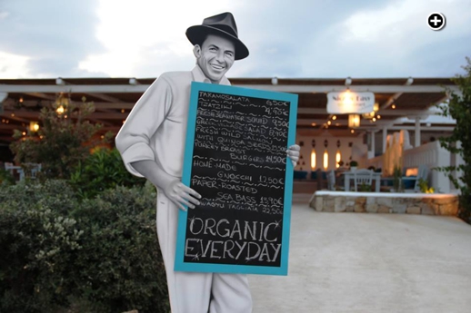 A Frank Sinatra menu board outside the entrance to Nice n Easy Bio restaurant at Kalo Livadi beach Mykonos