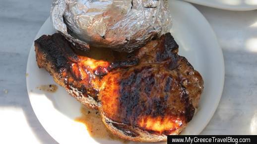 grilled pork chop and baked potato at Kiki's Taverna