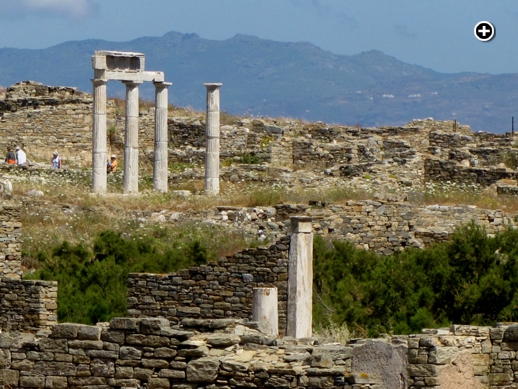 Tourists explore some of the historic ruins on Delos island near Mykonos