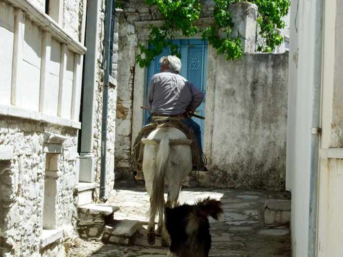 Mike Andrew photo of a man on a donkey in Apiranthos