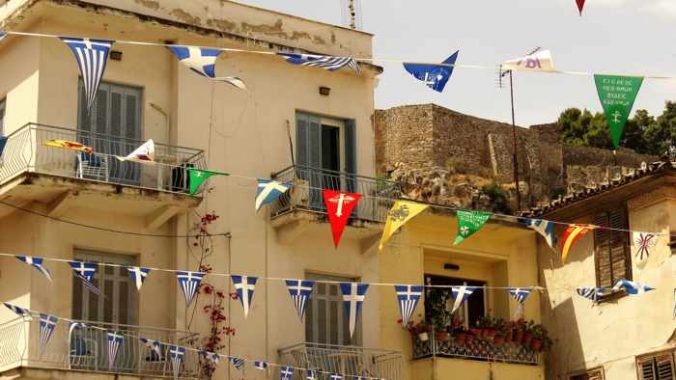 flags in the square next to Agios Georgios church