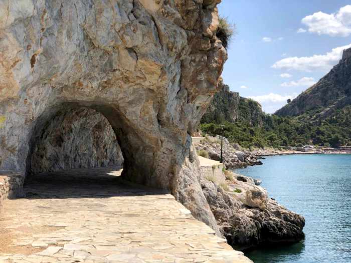 Greece, Peloponnese, Argolida, Nafplio, Arvanitia promenade, path, walkway, coast, tunnel, passageway
