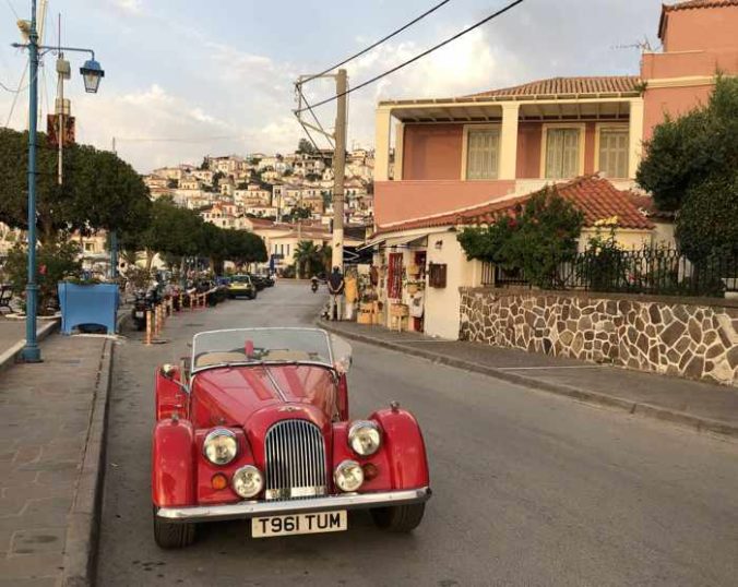 Greece, Greek island, Saronic island, Poros, Poros Greece, Poros island, Poros Town, street, road, buildings, vehicle, car, antique car,