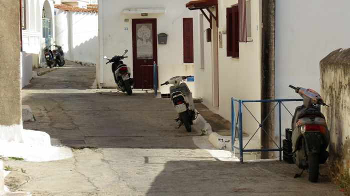 Greece, Greek island, Saronic island, Poros, Poros Greece, Poros island, Poros Town, street, lane, road, motorbikes, scooters, buildings, houses