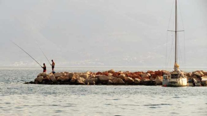 Greece, Peloponnese, Nafplio, Karathona, Karathona Bay, breakwater, jetty, fishermen, fishing,