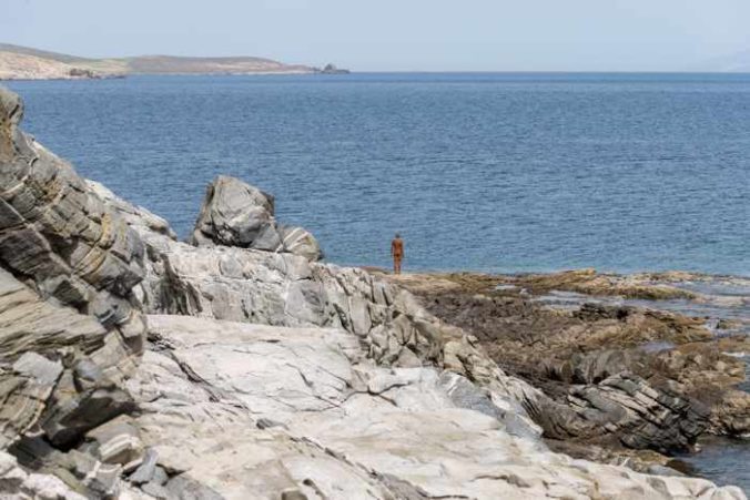 Photograph of the Antony Gormley sculpture Another Time XIV from 2011 on the coast of Delos island