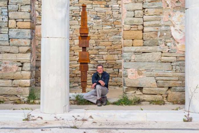 Sir Antony Gormley and one of the sculptures in his SIGHT installation on Delos as seen in a photo from the NEON page on Facebook