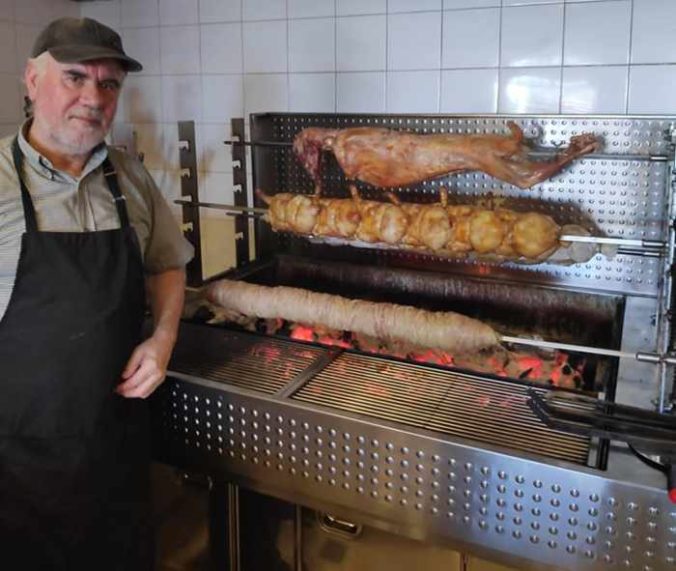 Taverna Kandavlos Facebook page photo of staff preparing rotisserie lamb chicken and pork