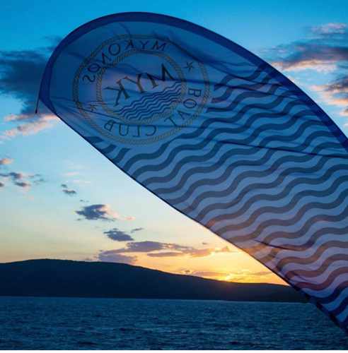 Mykonos Boat Club social media photo of a sunset view of Rhenia island