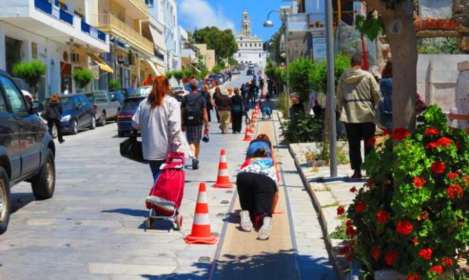 pilgrims crawling uphill to Evangelistria Church on Tinos island
