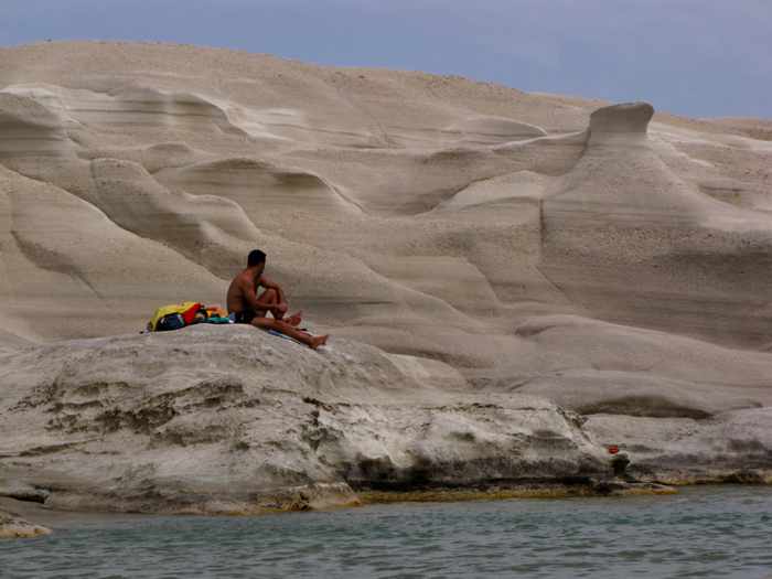 Sunbathers at the Sarakiniko beach and coastal area of Milos island