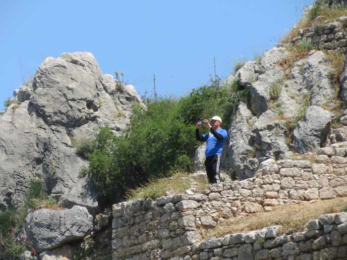 a tourist taking photos at Acrocorinth Castle